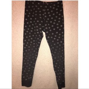 Black leggings with silver peace signs